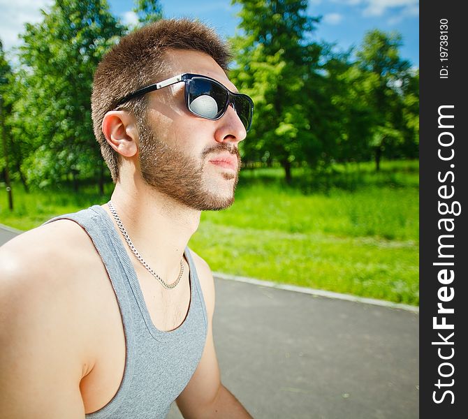 Young man in glasses on park. Young man in glasses on park