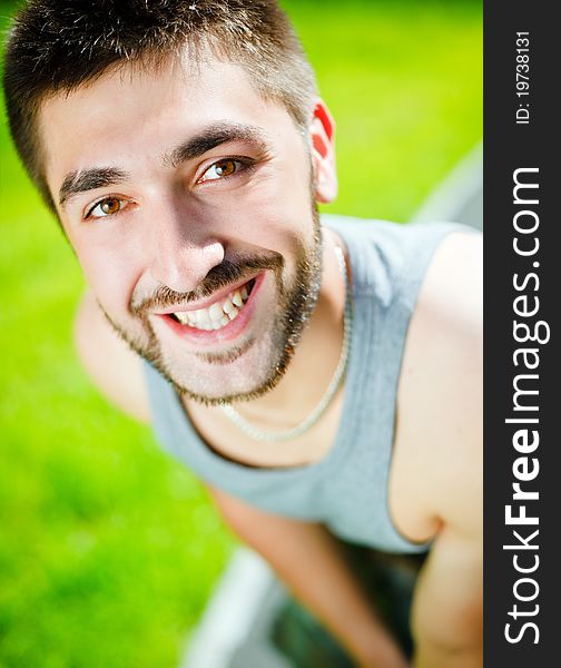 Young man smiling in park