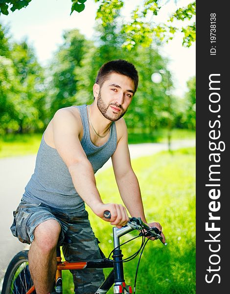 Young man cyclist sitting on bicycle
