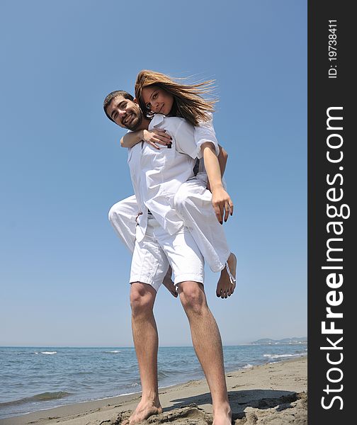 Happy young couple have fun and romantic moments on beach at summer season and representing happynes and travel concept. Happy young couple have fun and romantic moments on beach at summer season and representing happynes and travel concept