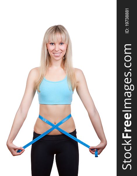 Attractive young and blond woman measuring size of her waist with a tape measure, smile, wear blue top. Vertical shot. Isolated on white background. Fitness concept. Attractive young and blond woman measuring size of her waist with a tape measure, smile, wear blue top. Vertical shot. Isolated on white background. Fitness concept.