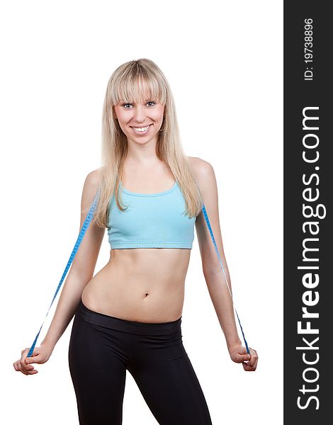 Attractive young and blond woman measuring size of her waist with a tape measure, smile, wear blue top. Vertical shot. Isolated on white background. Fitness concept. Attractive young and blond woman measuring size of her waist with a tape measure, smile, wear blue top. Vertical shot. Isolated on white background. Fitness concept.