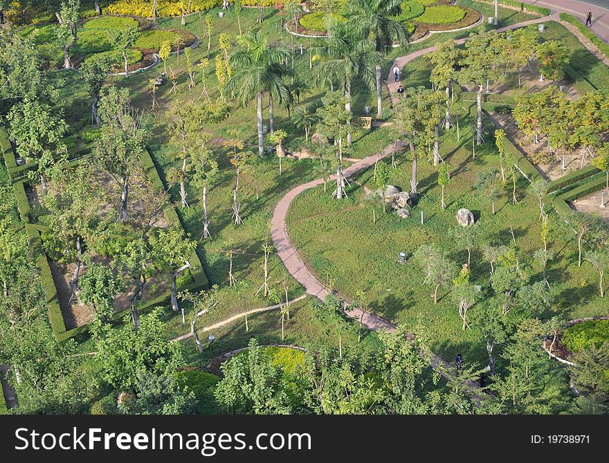 City garden with flourish trees,meadow,and a zigzag pavement footpath. City garden with flourish trees,meadow,and a zigzag pavement footpath.