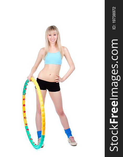 Young attractive woman holding hula hoop isolated over white background. Sport concept of girl exercising with hula hoop, twirling. Vertical shot. Young attractive woman holding hula hoop isolated over white background. Sport concept of girl exercising with hula hoop, twirling. Vertical shot.