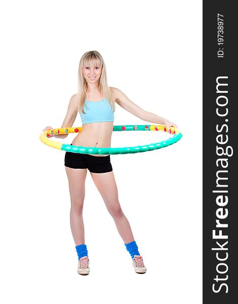 Young attractive woman holding hula hoop isolated over white background. Sport concept of girl exercising with hula hoop, twirling. Vertical shot. Young attractive woman holding hula hoop isolated over white background. Sport concept of girl exercising with hula hoop, twirling. Vertical shot.