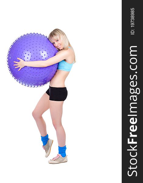 Young woman doing fitness exercise with a violet ball, smile. isolated over white background. Young woman doing fitness exercise with a violet ball, smile. isolated over white background.