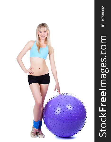 Young woman doing fitness exercise with a violet ball, smile. isolated over white background. Young woman doing fitness exercise with a violet ball, smile. isolated over white background.