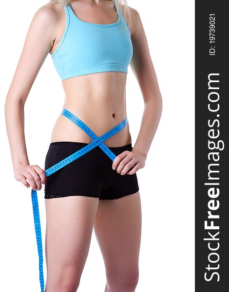 Attractive young athletic and woman measuring size of her waist with a tape measure, wear blue top. Vertical shot. Isolated on white background. Fitness concept. Attractive young athletic and woman measuring size of her waist with a tape measure, wear blue top. Vertical shot. Isolated on white background. Fitness concept.