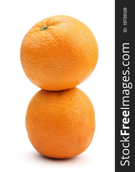Two oranges stacked together isolated over white background.