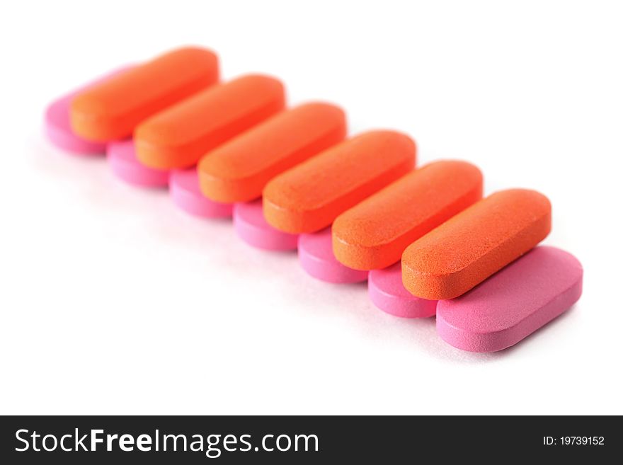 Many pills stacked together and isolated on white background.