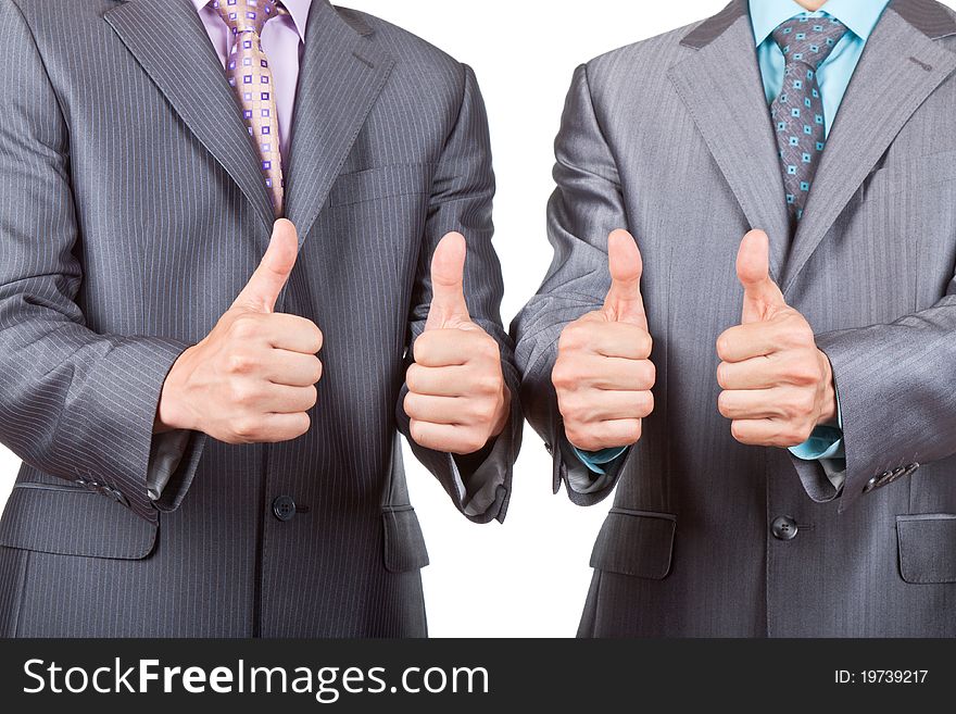 Two elegant businessmen standing and holding hands with thumbs up gesture, dressed in suit, shirt and tie. Concept Success, Approval, Good Work, isolated over white background. Two elegant businessmen standing and holding hands with thumbs up gesture, dressed in suit, shirt and tie. Concept Success, Approval, Good Work, isolated over white background.