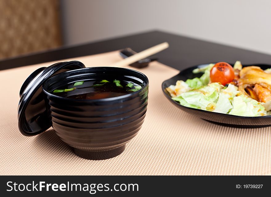 Japanese table place setting with soup and salad. Ready for dinner. Japanese table place setting with soup and salad. Ready for dinner