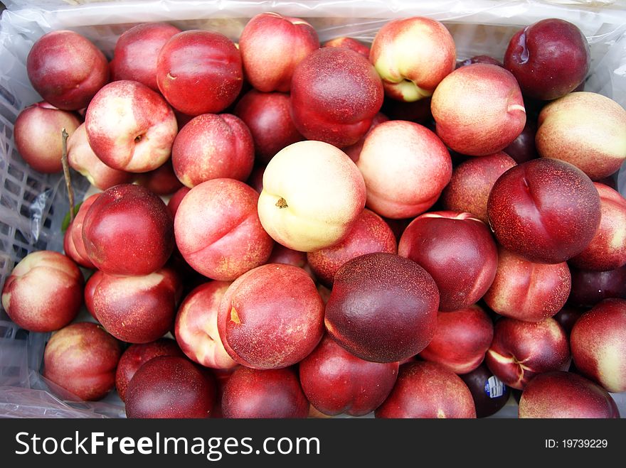 Bright red peach, is mature, and very sweet crisp. Put in the market for sale.
