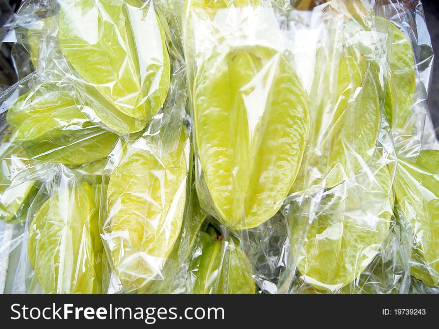 Carambola, by transparent plastic bag, sold on the market.