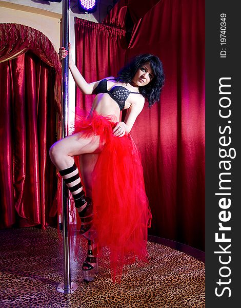 Stripper girl pole dancing in costume