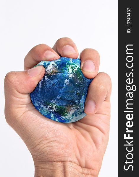 Hand squeezing earth on white background