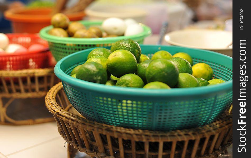 Green lemons and other vegetables at a Thai Food Market