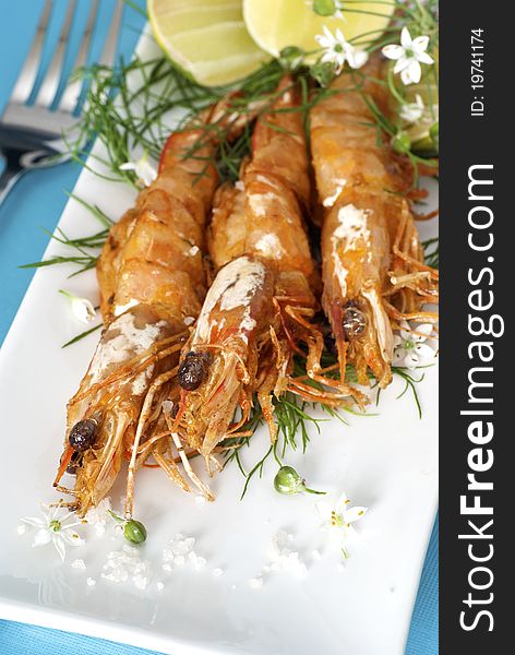 Freshly Grilled Prawns served as a Tapas dish, garnished with fresh dill and limes. Freshly Grilled Prawns served as a Tapas dish, garnished with fresh dill and limes