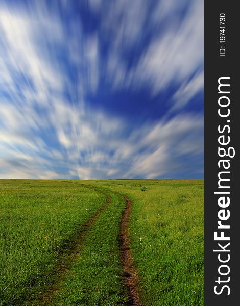 Blue sky with clouds over green field on a summer morning. Blue sky with clouds over green field on a summer morning