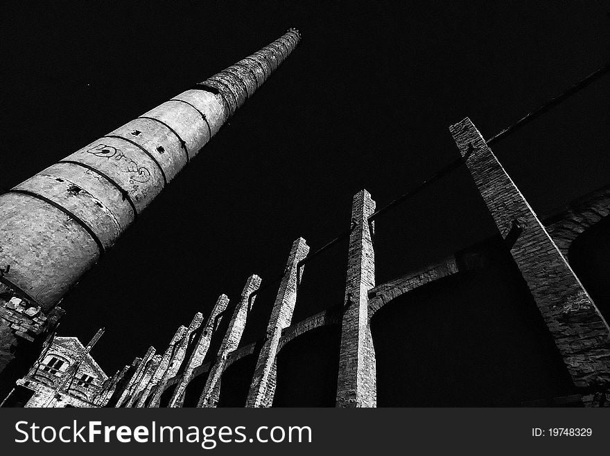 Ruined old foundry. Detail of chimney