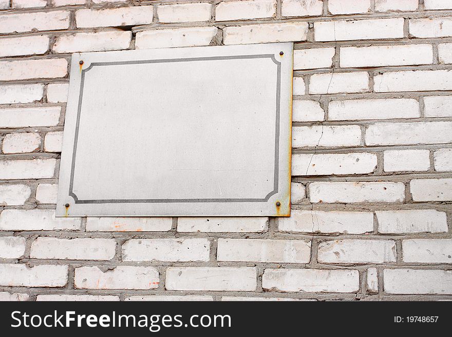 The image of signboard on the brick wall