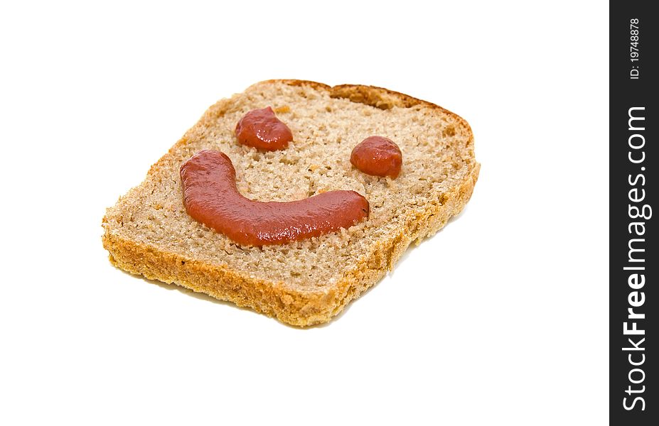 Smiley face on a piece of black bread isolated on white background