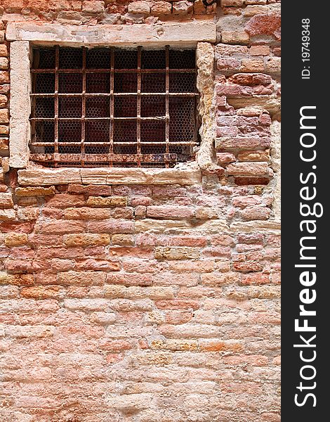 Grated window against brick wall. Grated window against brick wall