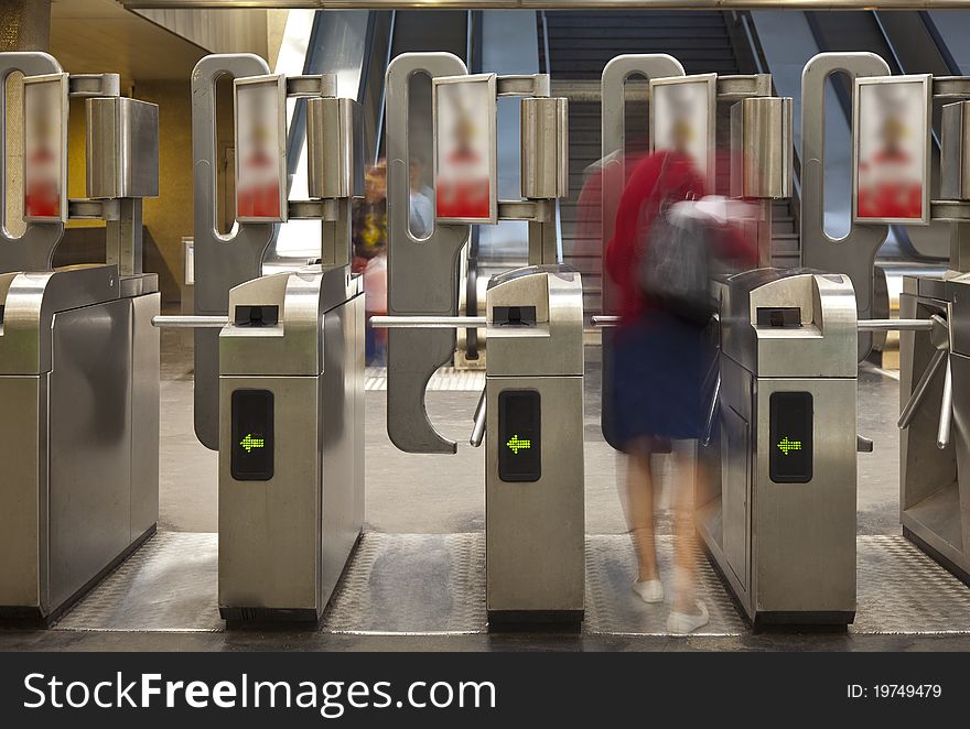 Blurred figure of person passing through subway turnstiles. Blurred figure of person passing through subway turnstiles