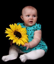 Infant Girl With Large Golden Sunflower. Isola Royalty Free Stock Image Infant Girl With Large Golden Sunflower. Isola Royalty Free Stock Image