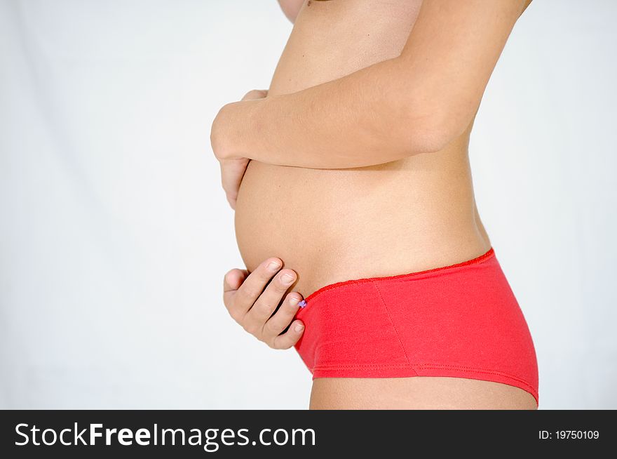 Five-month pregnant woman with red panties. Five-month pregnant woman with red panties