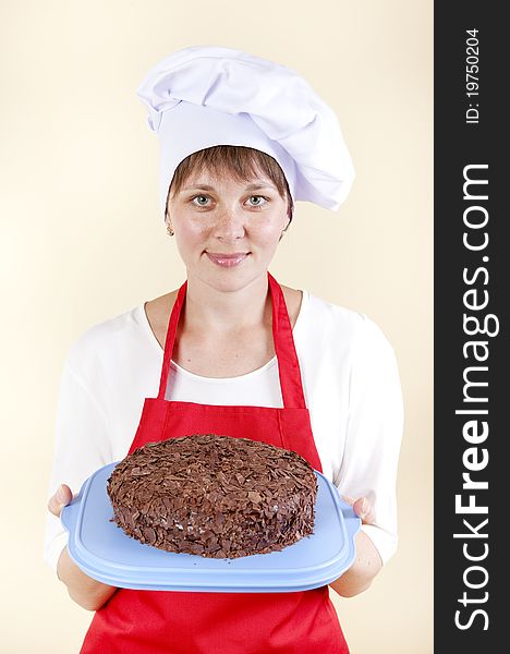 Girl Chef With A Cake In A Red Apron