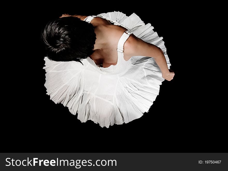 A beautiful ballerina dressed in white, dancing over a black floor. A beautiful ballerina dressed in white, dancing over a black floor