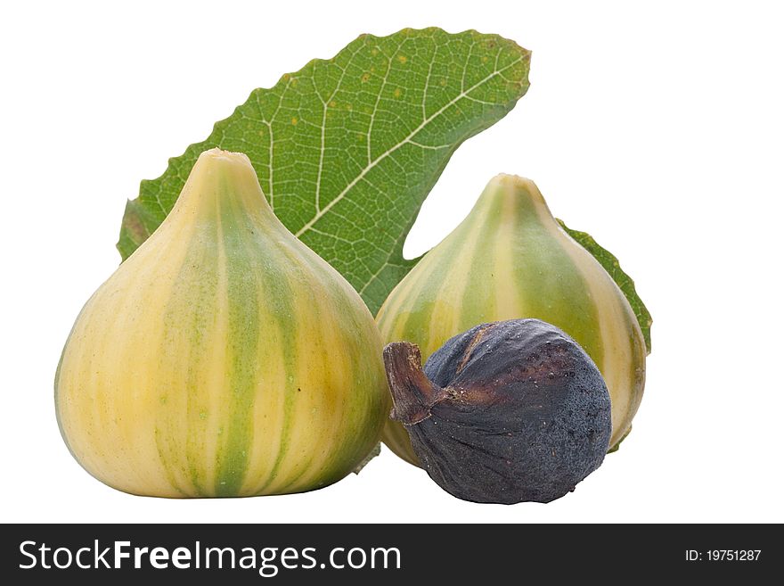 Ripe fruits of a fig on a white surface.