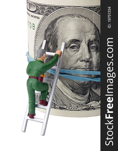 Miniature man climbing a roll of American money. Miniature man climbing a roll of American money.