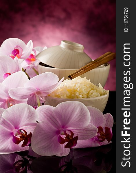 Photo of delicious asian rice dish with orchid flowers around