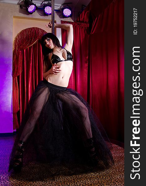 Stripper girl pole dancing in costume