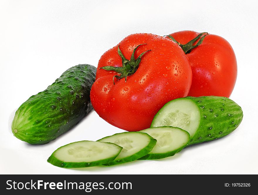 The Juicy ripe tomatoes in drop of water on white background.