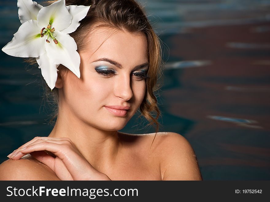 Portrait of young girl with flower in water