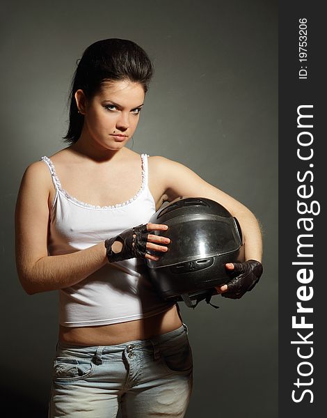 The girl with a motorcycle helmet on a gray background