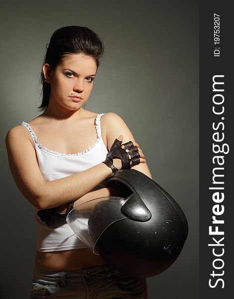 The girl with a motorcycle helmet on a gray background