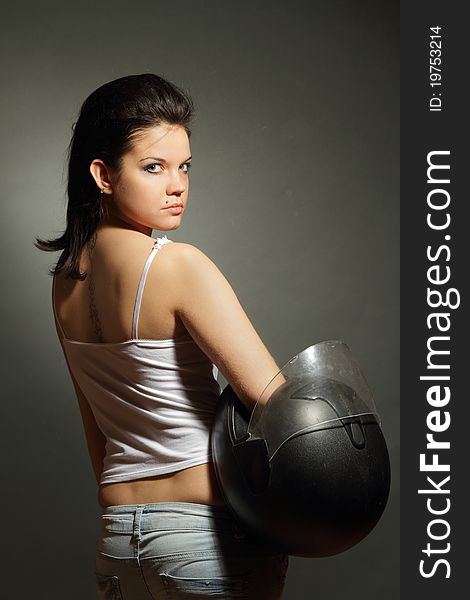 The girl with a motorcycle helmet on a gray background