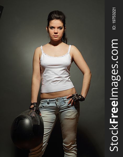 The girl with a motorcycle helmet on a gray background