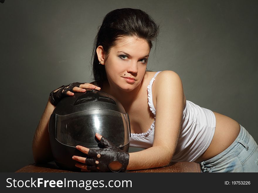 The girl with a motorcycle helmet on a gray background