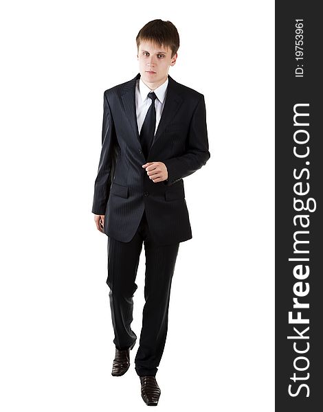 Young business man seriously walk forward on white background