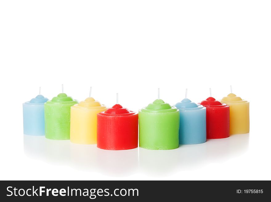 Colorful short candles without flame. Isolated over white background. Colorful short candles without flame. Isolated over white background