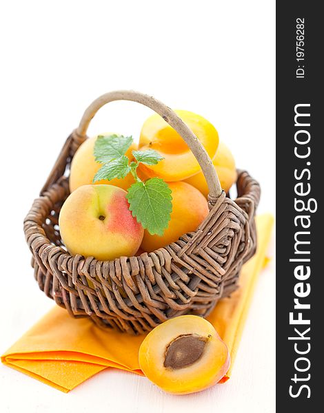 Fresh apricots in a basket with mint