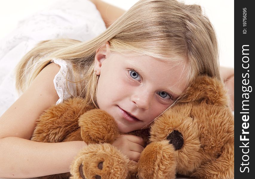 Angelic little girl with her teddy bear on white. Angelic little girl with her teddy bear on white.