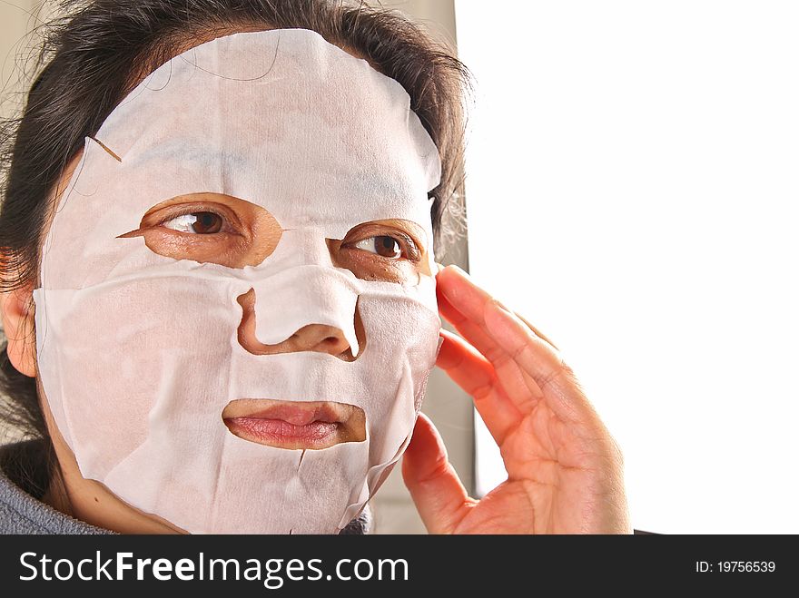 Chinese woman wearing a facemask. Close up