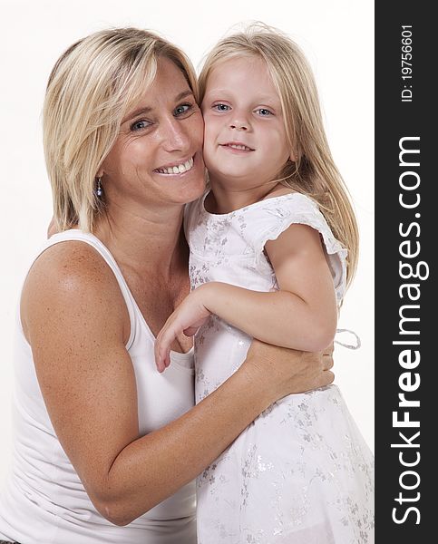 Attractive blonde mother and daughter, in a loving embrace. Attractive blonde mother and daughter, in a loving embrace.