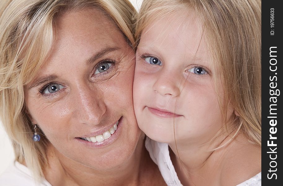 Attractive blonde mother and daughter, in a loving embrace. Attractive blonde mother and daughter, in a loving embrace.